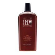 A bottle of American Crew 3-in-1 Shampoo, Conditioner and Body Wash, 33.8 oz size, with a predominantly brown label.