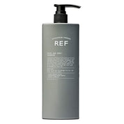 Gray shampoo bottle with pump labeled 'REF' on a white background