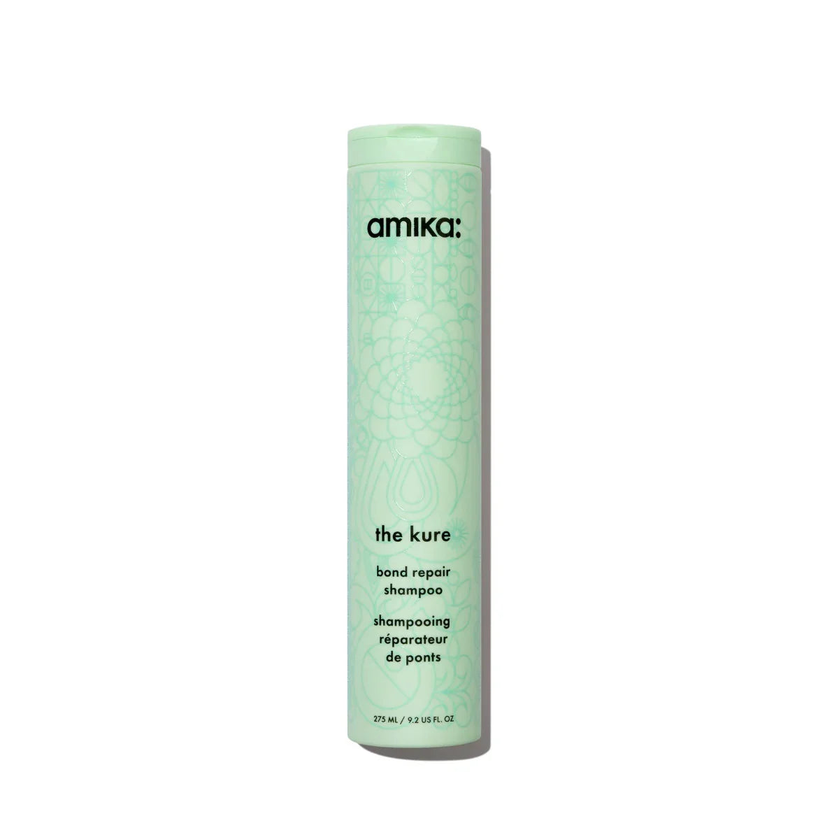 Amika 'the cure' bond repair shampoo bottle on a white background