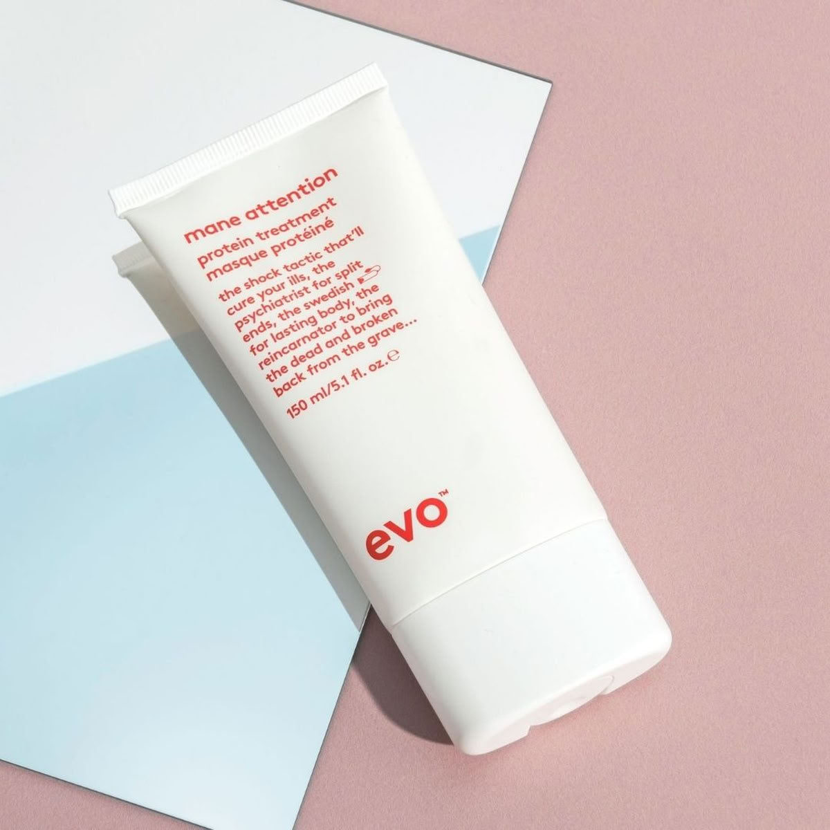 White hair treatment product with red text and 'evo' logo on a pink and blue background