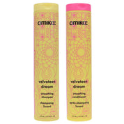 Two bottles of Amika Velveteen Dream shampoo and conditioner on a white background
