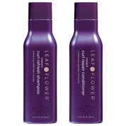 Two purple bottles of Leaf Flower shampoo and conditioner on a white background
