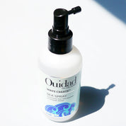 Ouidad hair care product bottle on a white background