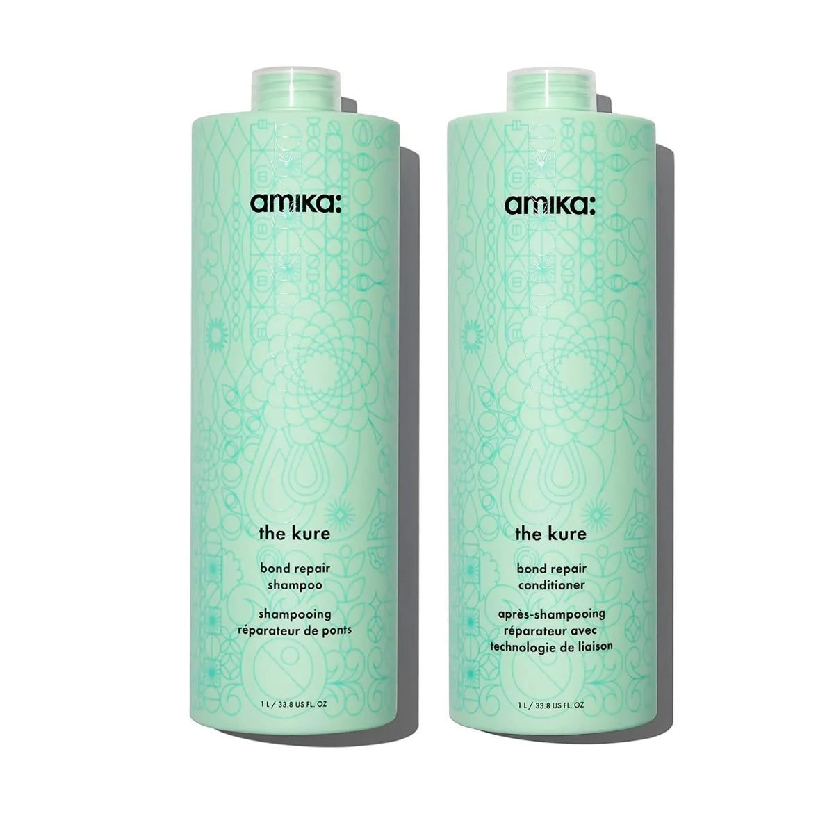 Two bottles of amika 'the cure' bond repair shampoo and conditioner on a white background