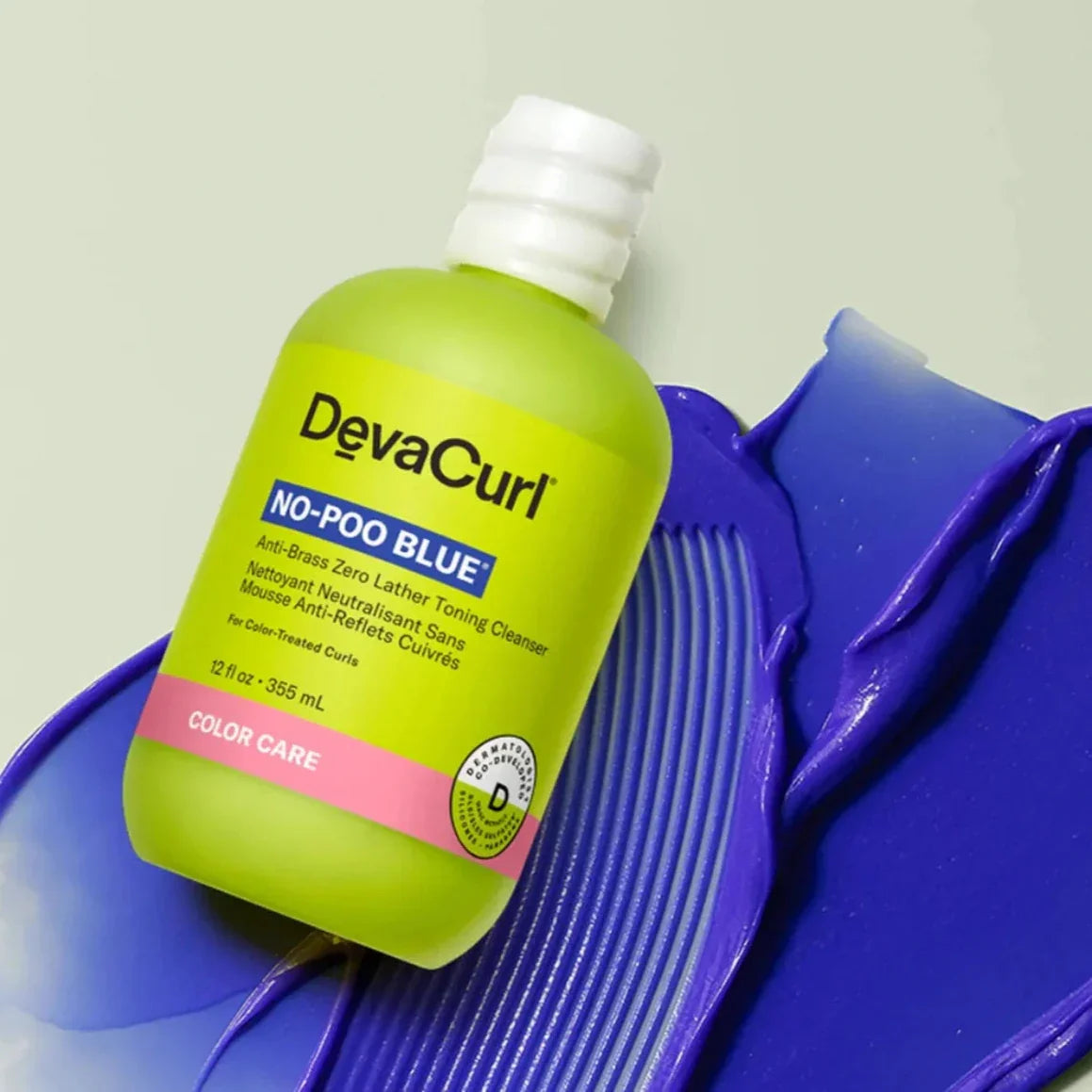 Devacurl No-Poo Blue bottle on a purple background