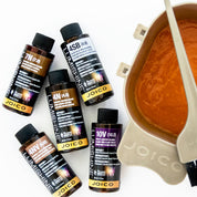Joico hair color products with a color mixing bowl and brush on a white background