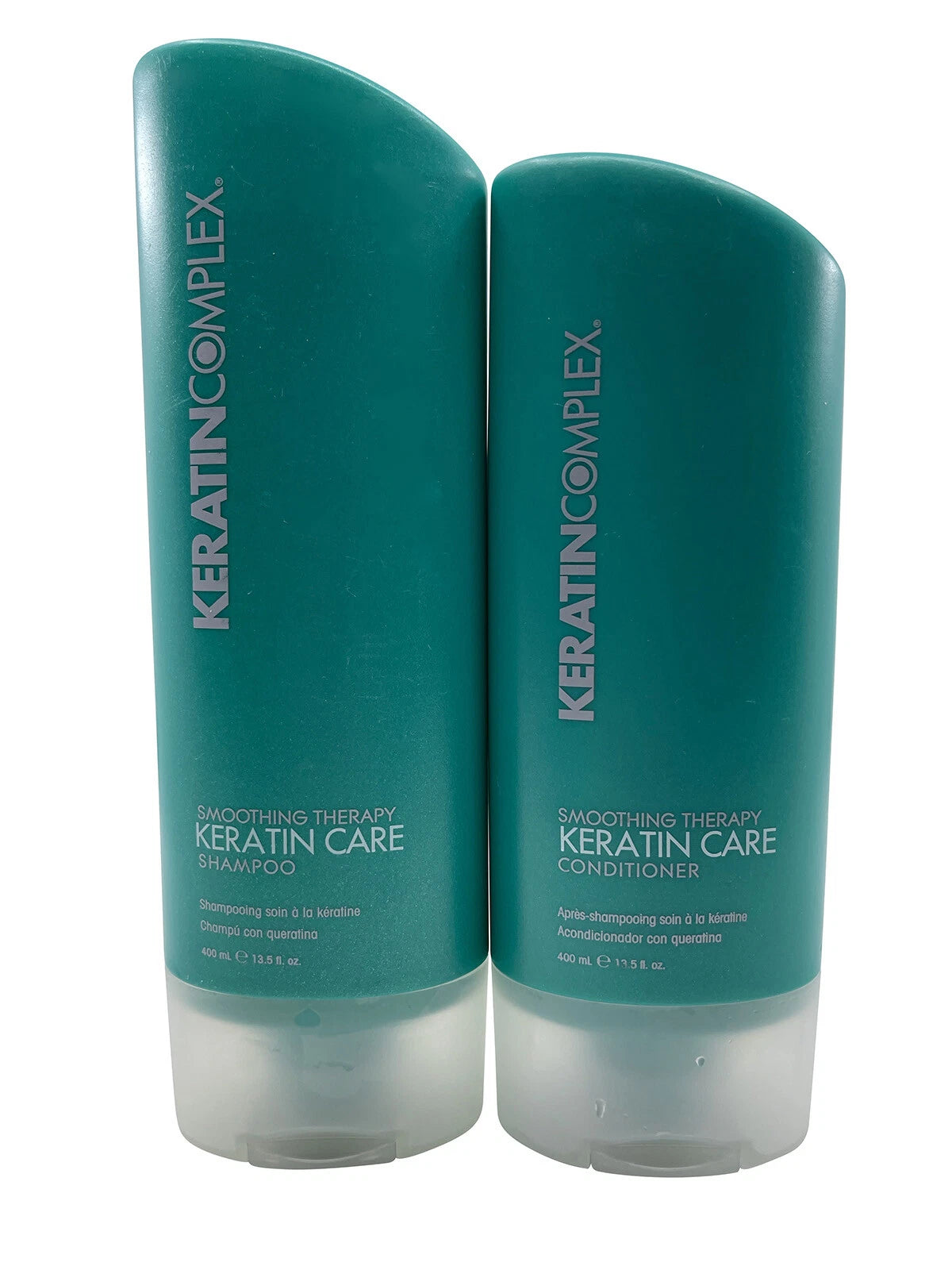 Two bottles of Keratin Complex Keratin Care Shampoo and Conditioner on a white background